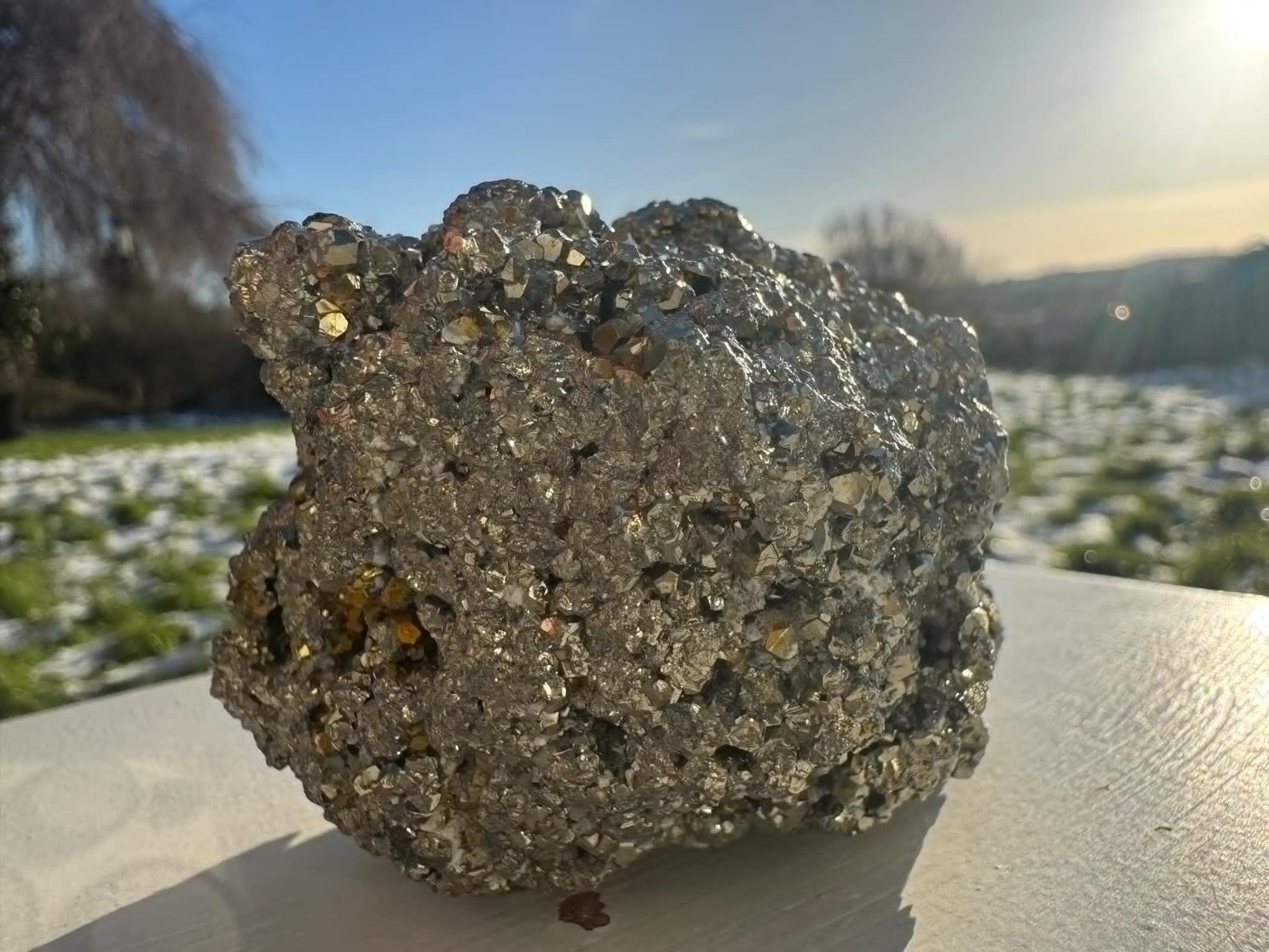 rough piece of pyrite, also known as fool's gold, characterized by its metallic luster and pale brass-yellow hue.